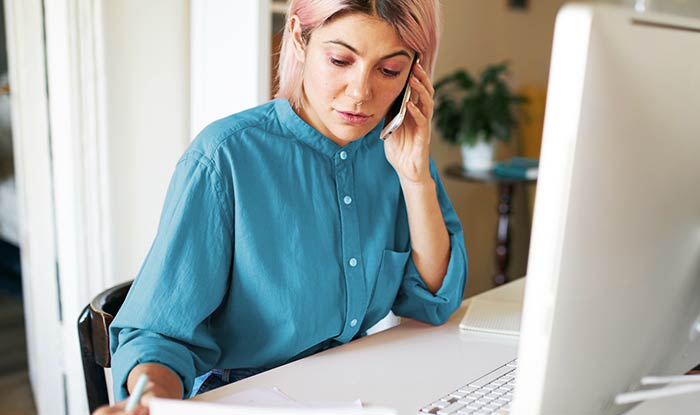 Service Delivery Manager for the Testa Software Testing Lifecycle at a desk talking on the phone